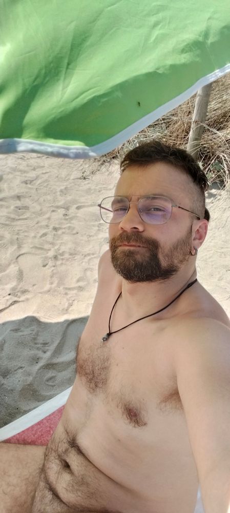 Me sitting at the nude beach under an umbrella.