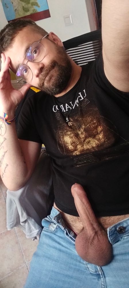 Me sitting on my computer chair, dressed but with my dick and balls out of the fly.