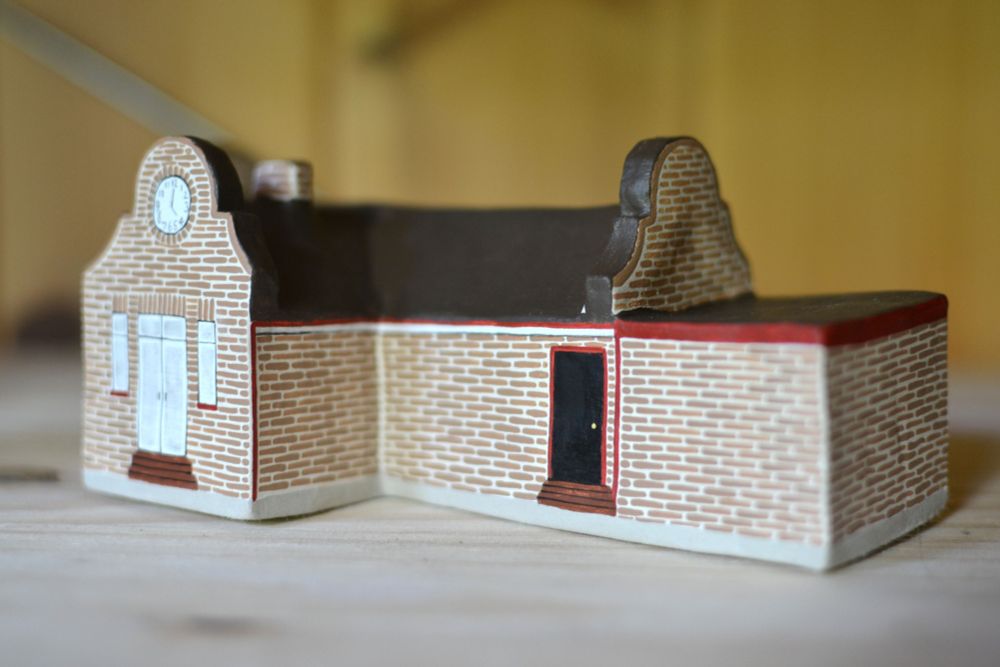 Little painted clay model of the Taskmaster House.