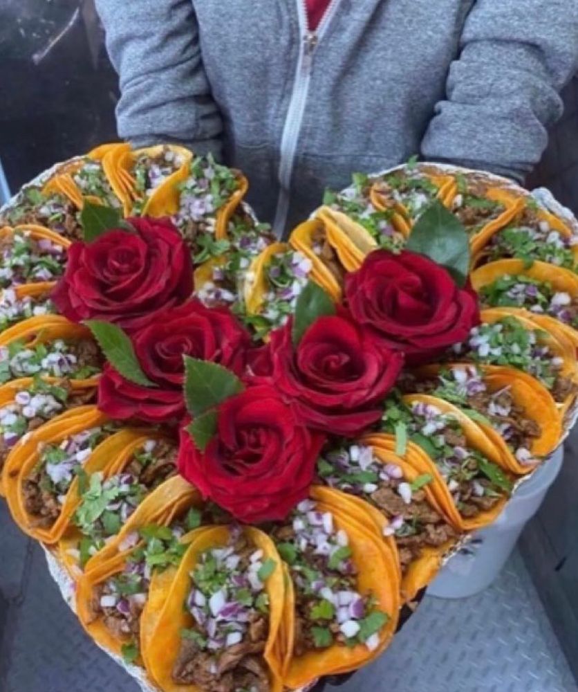 Heart shaped tray of tacos with red roses in the center