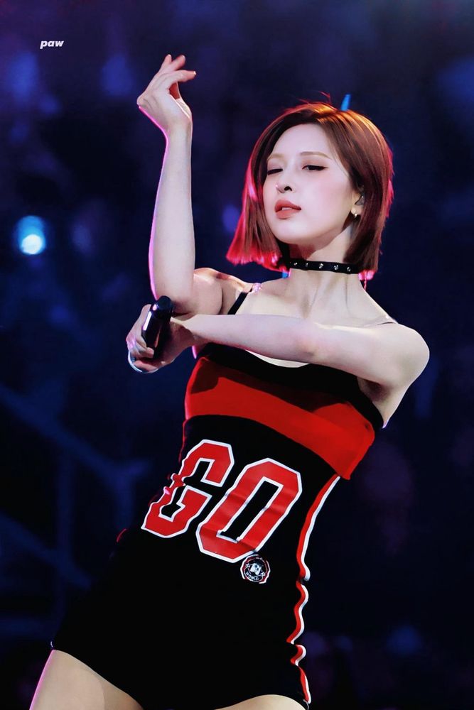 Photo by fansite paw of bae from kpop group nmixx in a black and red jersey style dress mid performance on stage at kcon