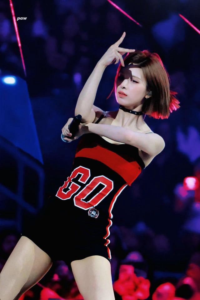 Photo 2 by fansite paw of bae in a black and red jersey style dress mid performance on stage at kcon