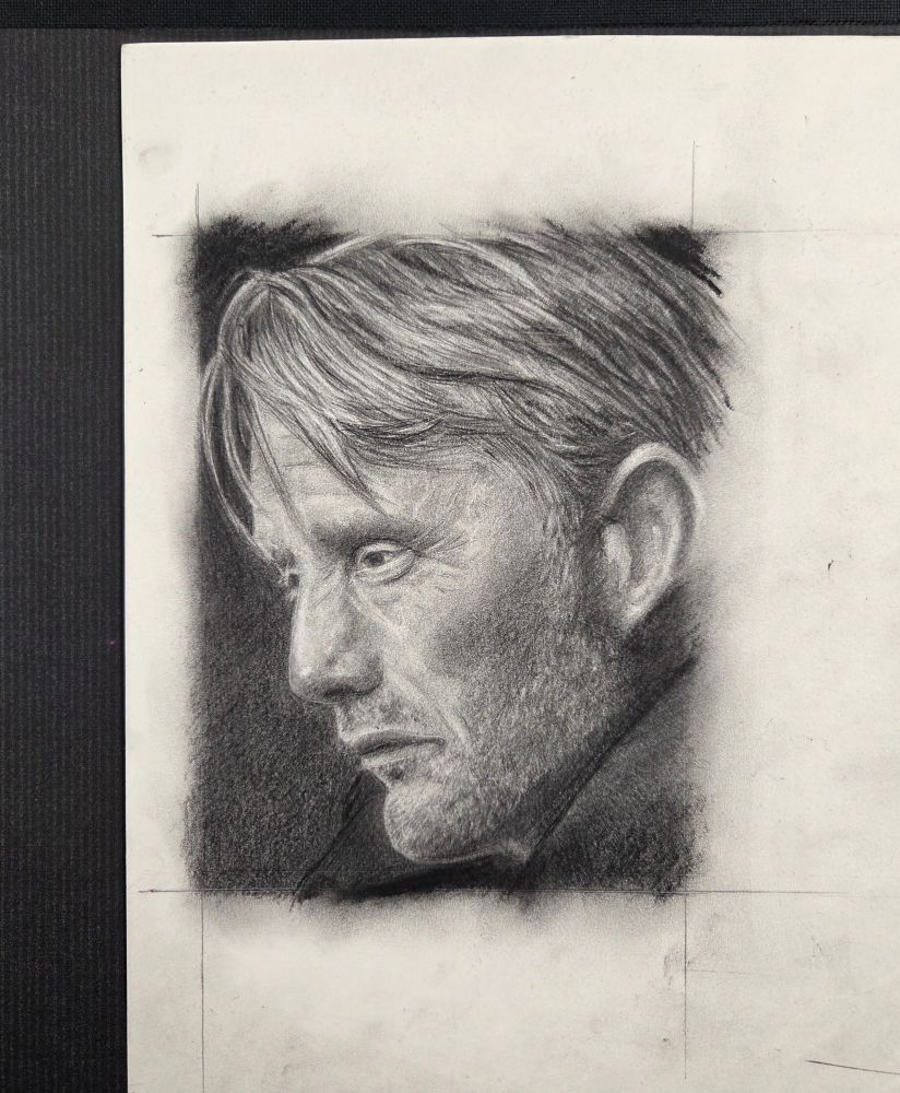 Pencil drawing of side portrait of Danish actor Mads Mikkelsen. Portrait is made in black and white.