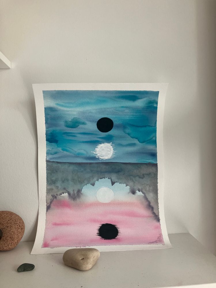A watercolour and acrylic piece depicting a black and white moon reflected in water - the water is pink while the sky is blue 