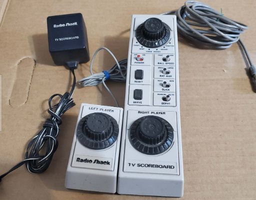 Radio Shack version of Pong game to hook up to your home tv. Multiple dials and buttons, power adapter, and wire to connect to the TV.