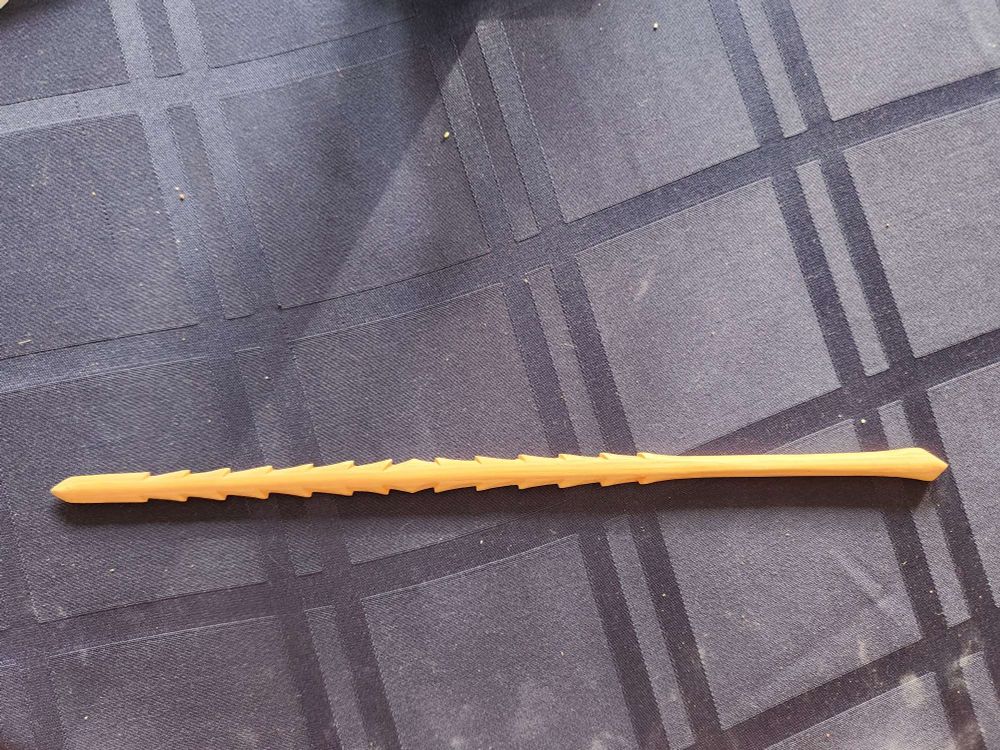 A long stick with a pattern of points
