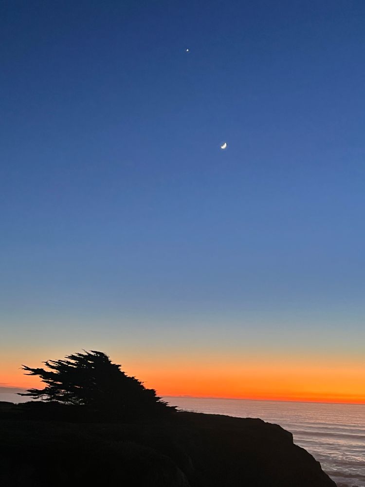 Half Moon Bay sunset with crescent moon. 