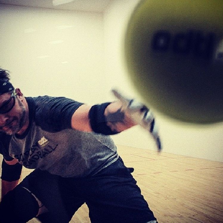 Ben Edtl in a funny little athletic fit throwing a ball at his phone