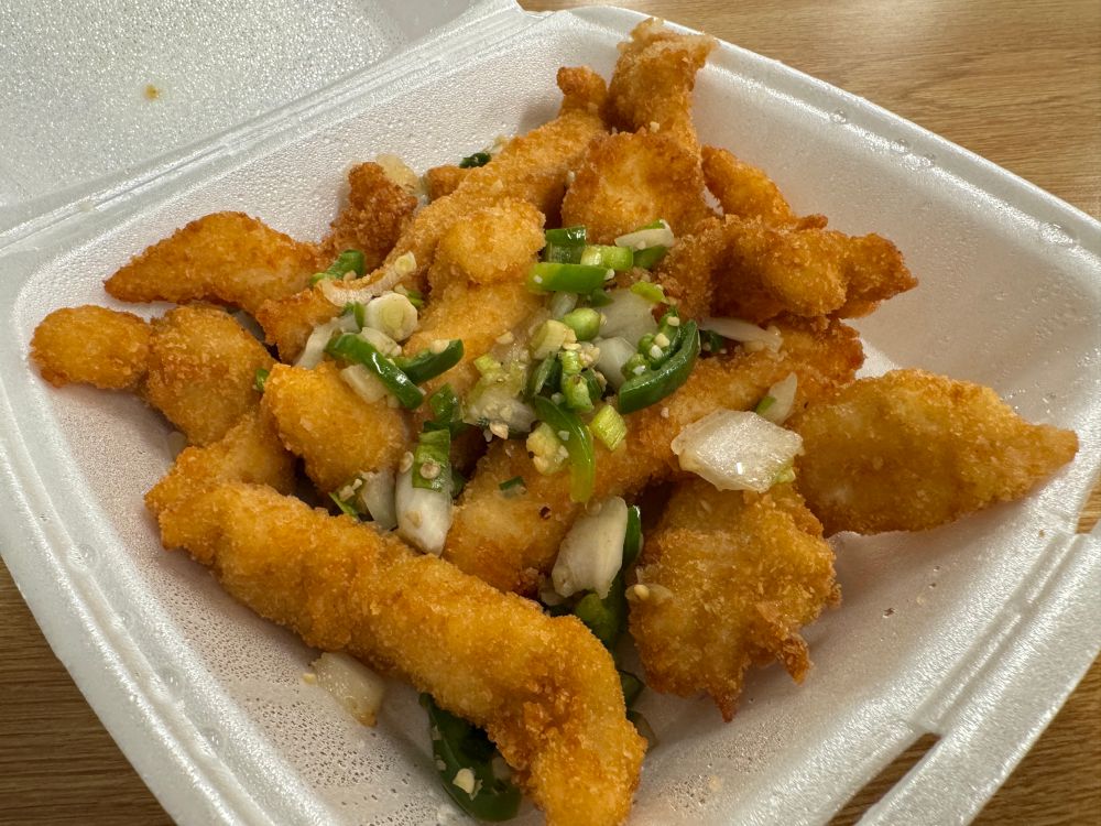 Fillet of fish that is battered and fried and then stirred with some salt, pepper, scallions, and jalapeños. 

Delicious. 