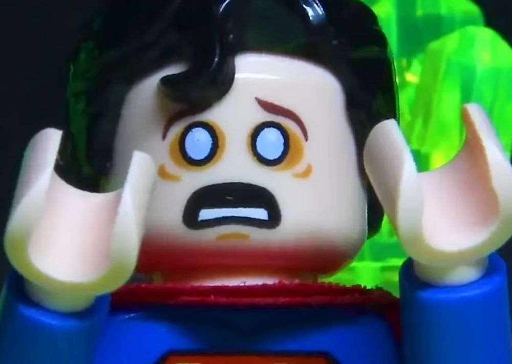 Lego Superman with bags around his eyes (possibly when he gets exposed to kryptonite & has his reaction) with his hands up looking panicked.