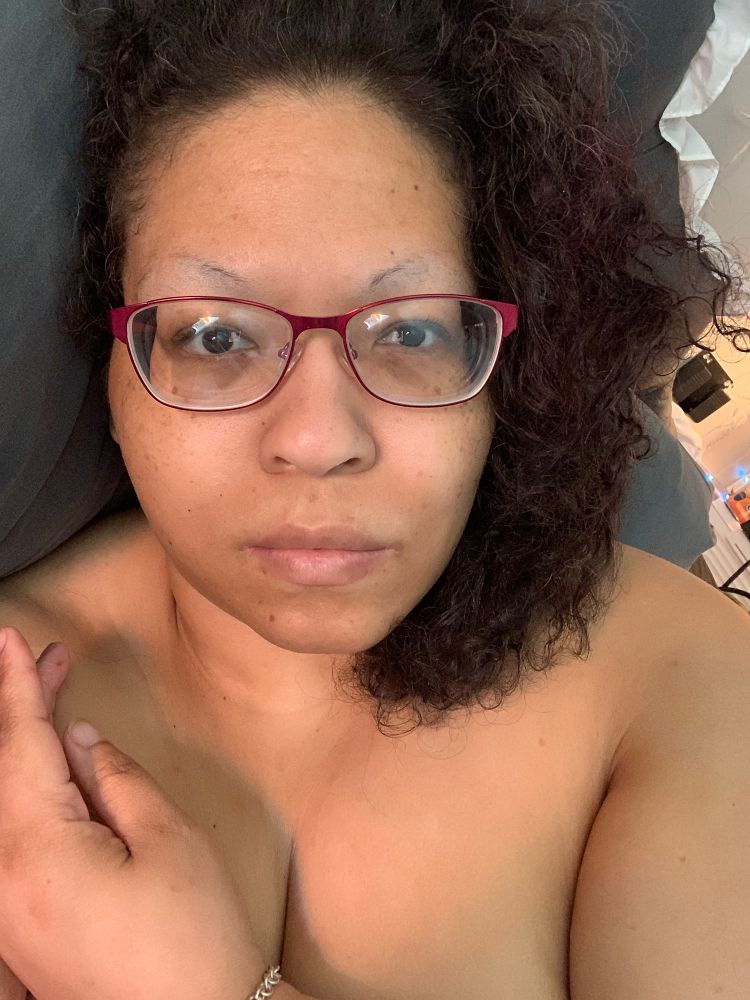 Barbie naked with her arm over her breasts, her hair is curly & she has her pink glasses on. She has a slight smile and is leaning on a pillow. Because she literally woke up like this. 