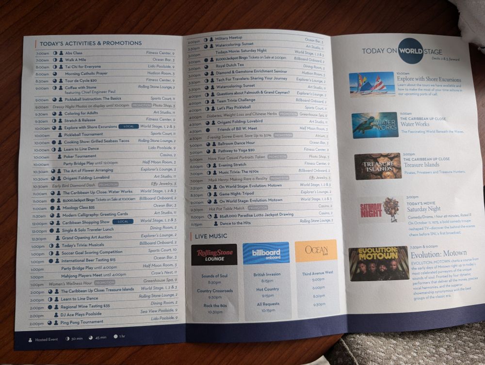 A picture of a large tri fold paper detailing all the activities and times for a day on a Holland America cruise ship
