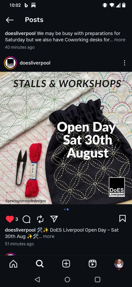A sashiko-embroidered drawstring bag with scissors and red sashiko thread, against a background of sashiko-embroidered cloths
