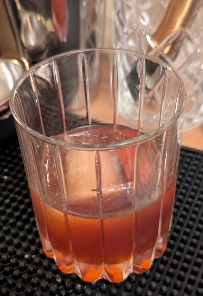 A chocolate tequila negroni in a rocks glass