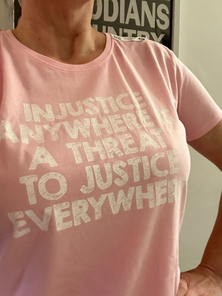 Tshirt bearing the Martin Luther King quote “injustice anywhere is a threat to justice everywhere.”