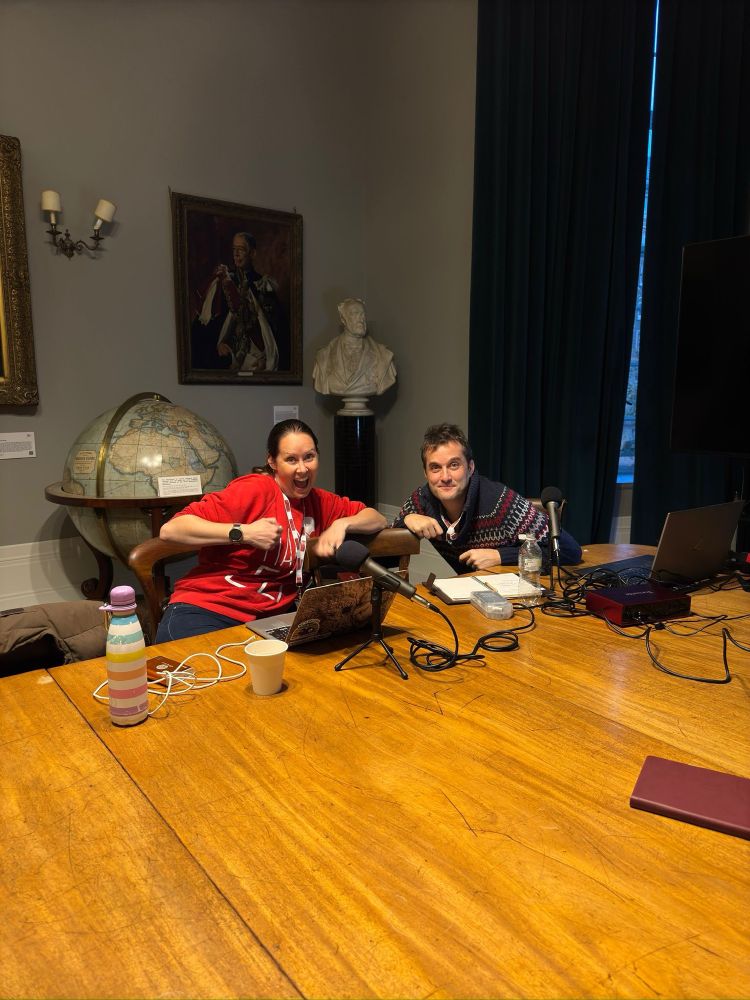 Nat and Iain posing in the Council Room at the Royal Geographical Society, surrounded by podcasting equipment. Iain looks demure and Nat looks demented. Credit for photo to Zaf Qasim :)