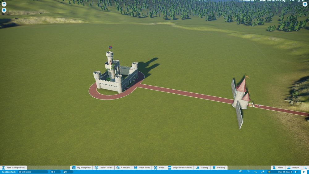 Screenshot of Planet Coaster. Castle-themed entryway, path, and castle.