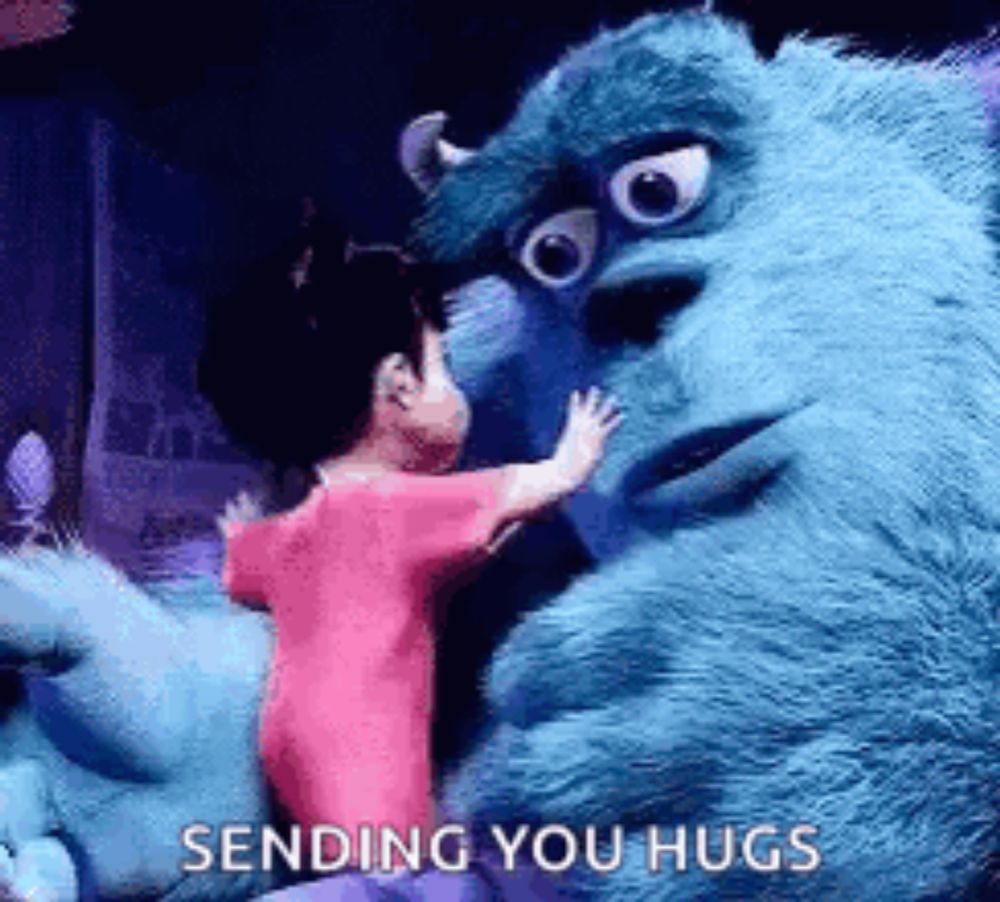 a little girl is hugging a stuffed animal from monsters inc .