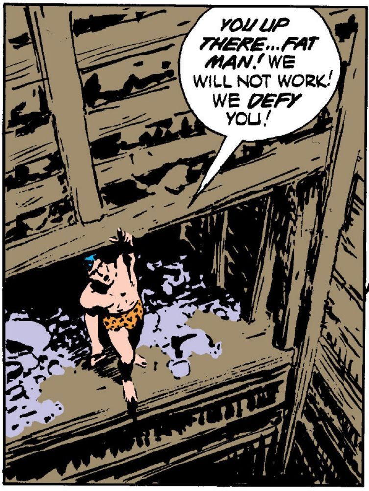 Tarzan stands at the edge of a deep elevator mine shaft, pointing upward and says, “YOU UP THERE… FAT MAN! We will not work! We DEFY you!“
