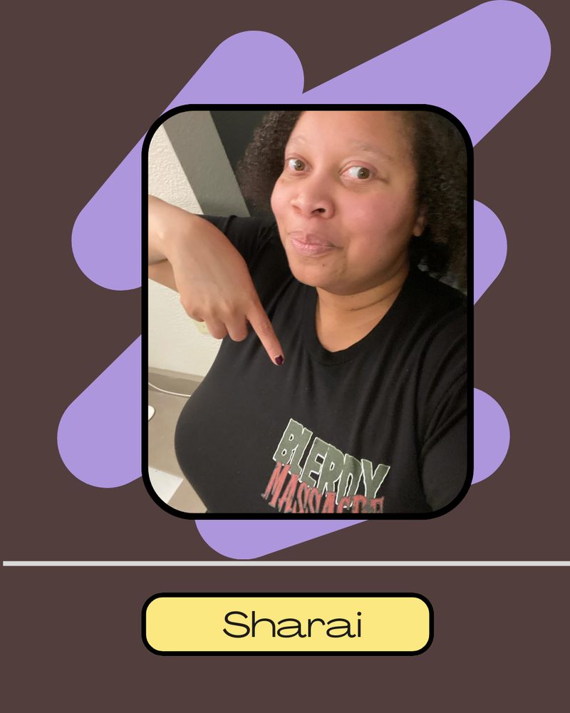 A person named Sharai pointing to a black shirt with a “Blerdy Massacre” logo