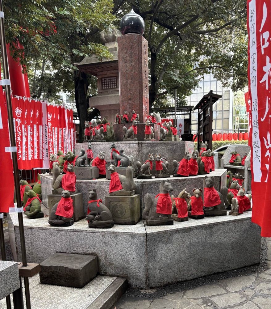 A shrine with numerous small stone fox statues