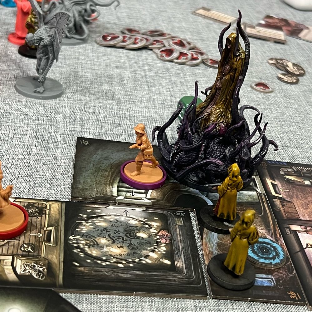 Cthulhu Death May Die board game set up. Hastur and Hastur Disciples painted and other unpainted minis around. 