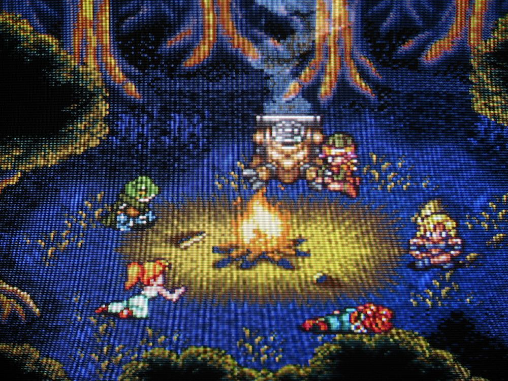 Gathered around a calming campfire in the woods, Lucca repairs Robo and the crew philosophize about their predicament on the eve of the final battle.