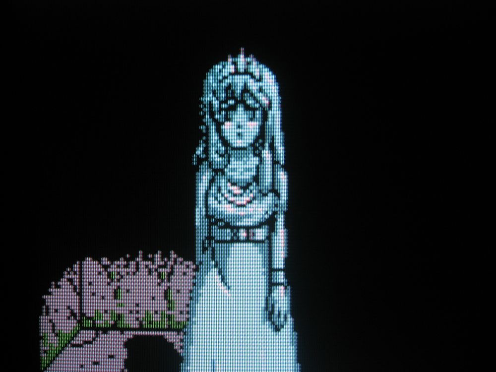 Princess Felicia, now turned to stone, can be visited whenever the player returns to town, in case you need to be reminded of your motivation. In this depiction, her facial expression is more dire. She stands alone in a dark room, sadly.
