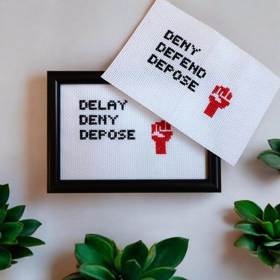Embroidery of a red fist accompanied by the words 