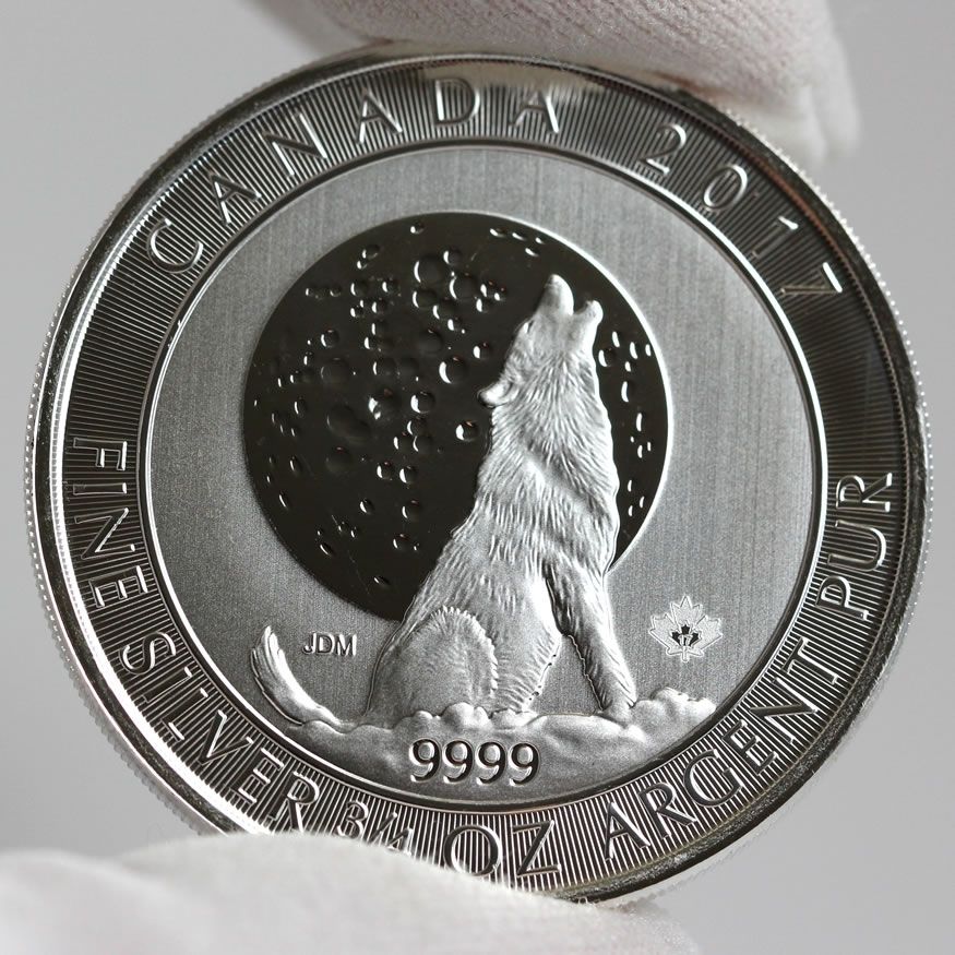 Canadian silver coin with a wolf howling in front of a moon.  The wolf's fur is clearly minted.
