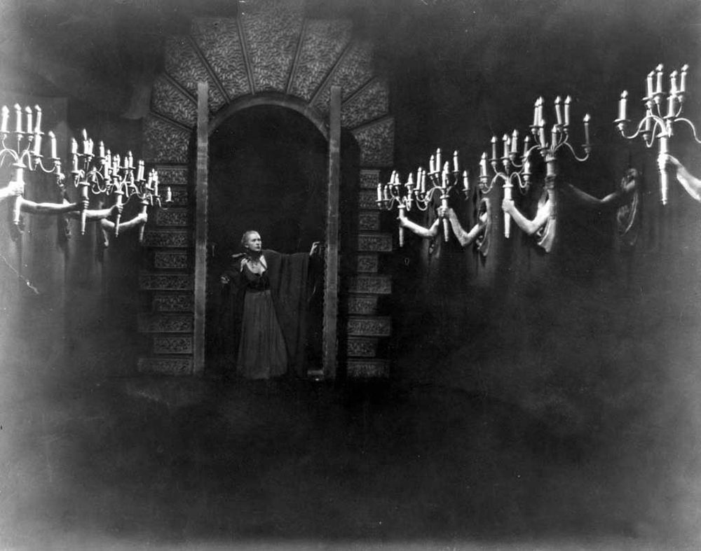 belle in candle-lined hall