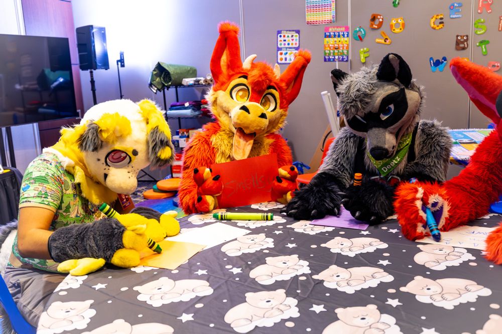 Me (Kaiser), Hellsy, Deetz and Hex’s ear and arm drawing on paper with giant crayons.