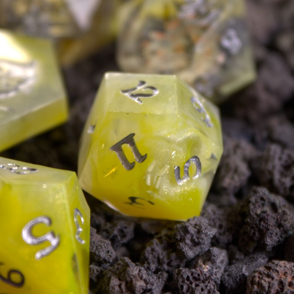 Swirling yellow resin with silver glitter and foil.