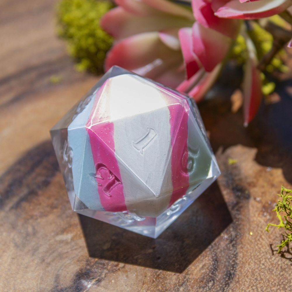 Trans Pride flag painted on the underside of the dice