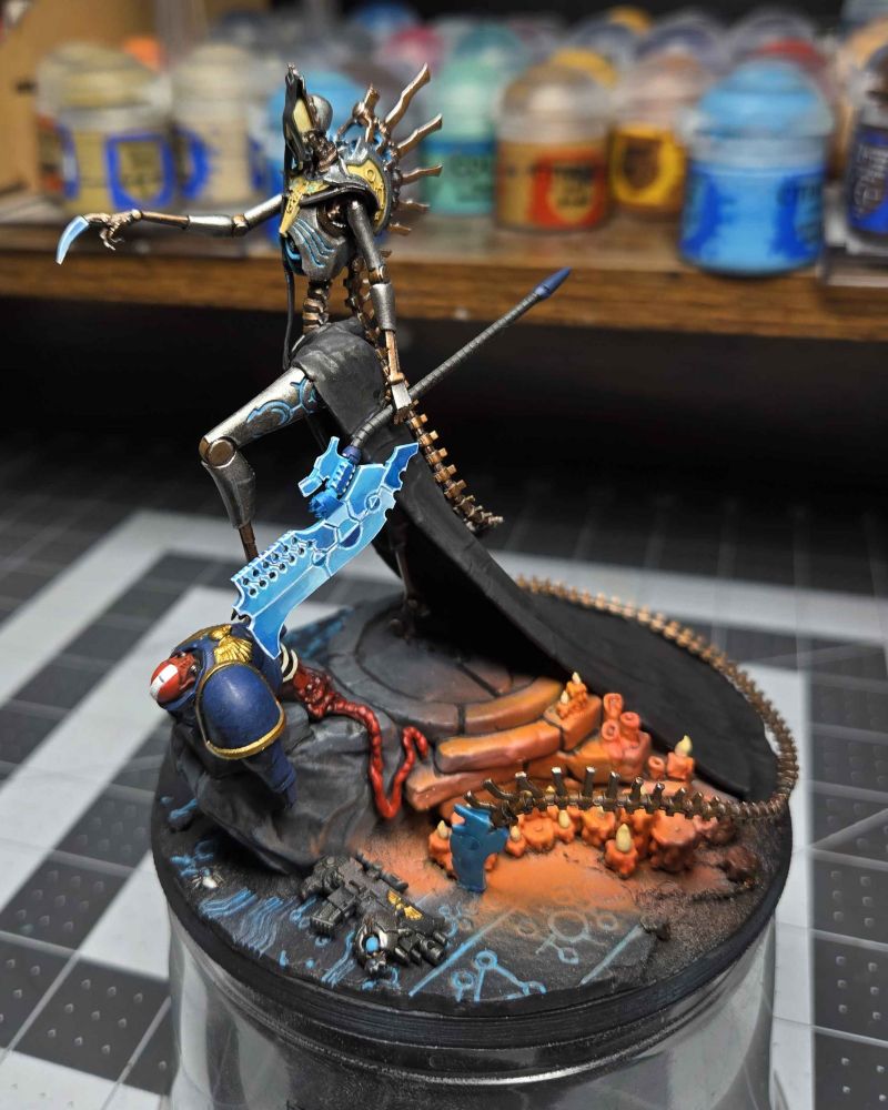 3D printed Necron model from the side holding a painted hyperphase blade.