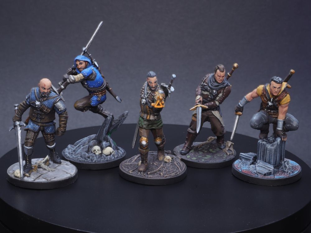 Five painted Witcher miniatures from the board game Witcher: Old World. From left to right; Wolf, Cat, Griffin, Bear, and Viper