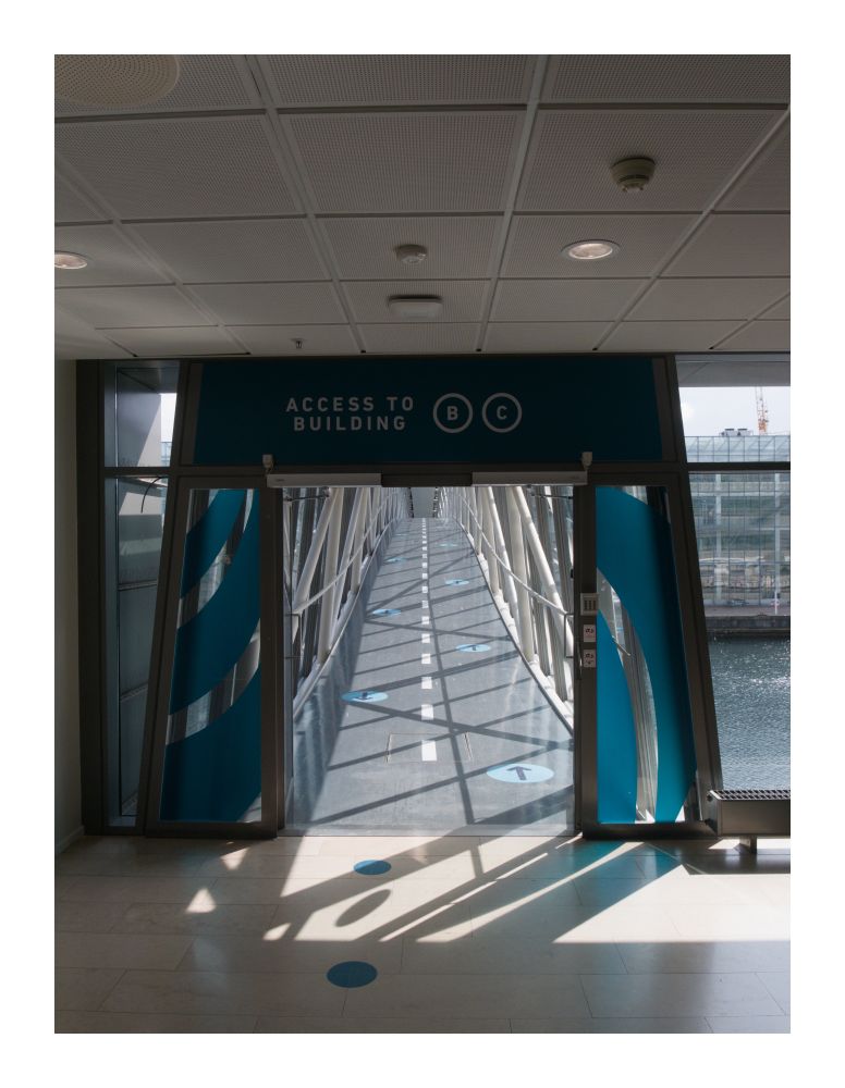 The entrance to the bridge from one building.