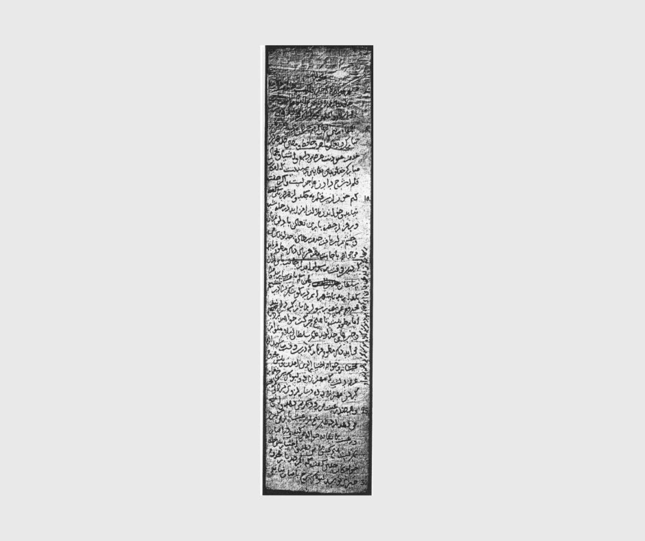Image is of a light grey background, on which a long thing document appears. It is written in New Persian in Arabic script, black ink on a light background - the photography is probably black and white and is not high resolution so it is hard to make out the detail. There are fold lines and staining identifiable.