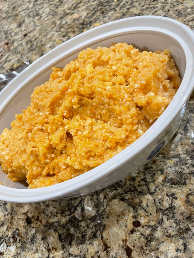 A casserole dish filled with mashed sweet potatoes not baked  