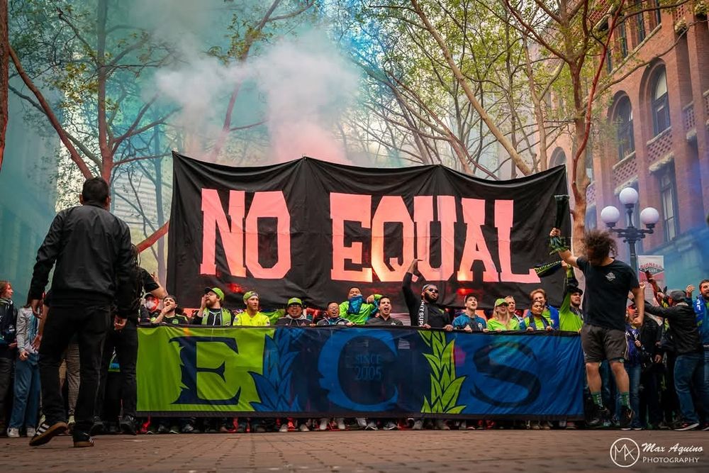 Banners in a march:
"NO EQUAL"
"ECS"