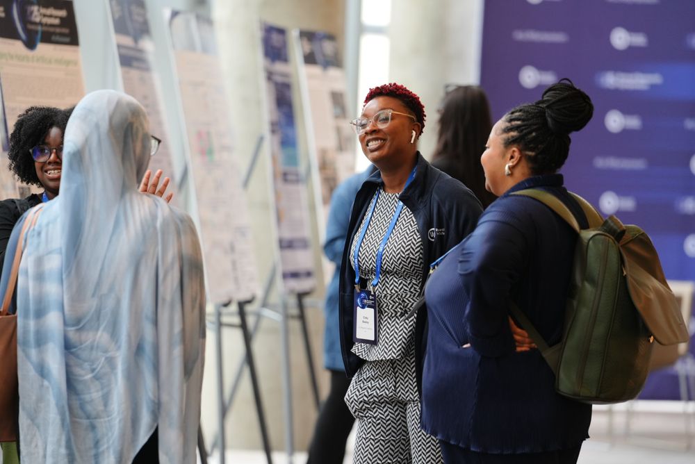 UL interns chat next to the research poster session at the Third Annual Research Symposium in Washington, D.C.