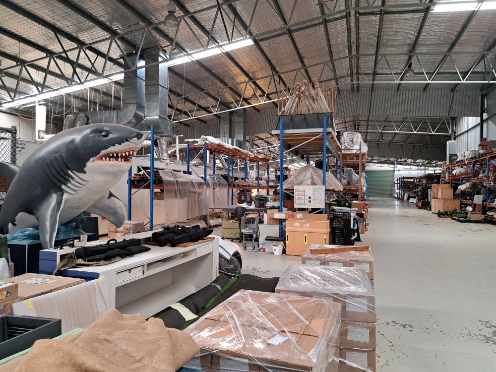 A museum warehouse, with a fibreglass shark model on the left