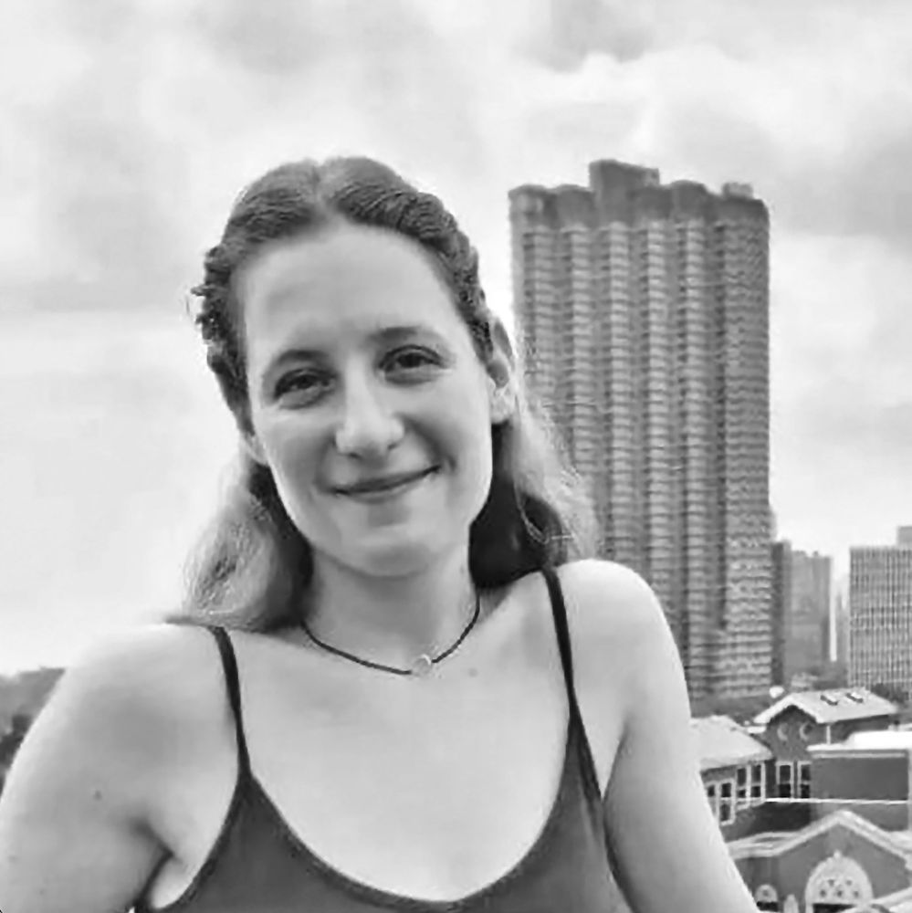 Headshot of Rhea Ienni in front of a city skyline.