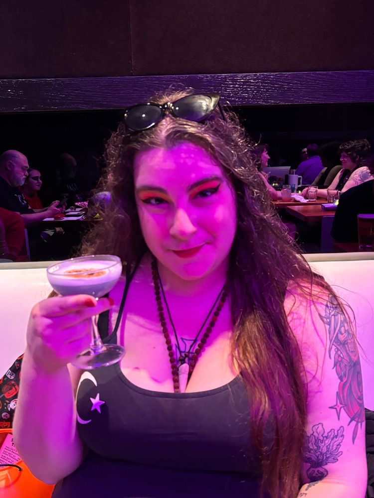 Goth girl with tattoos looking at you