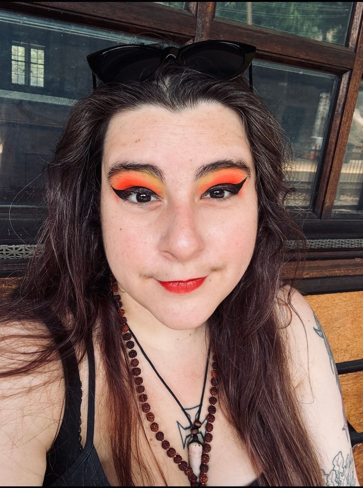 Goth Girl with Red makeup looks at you 