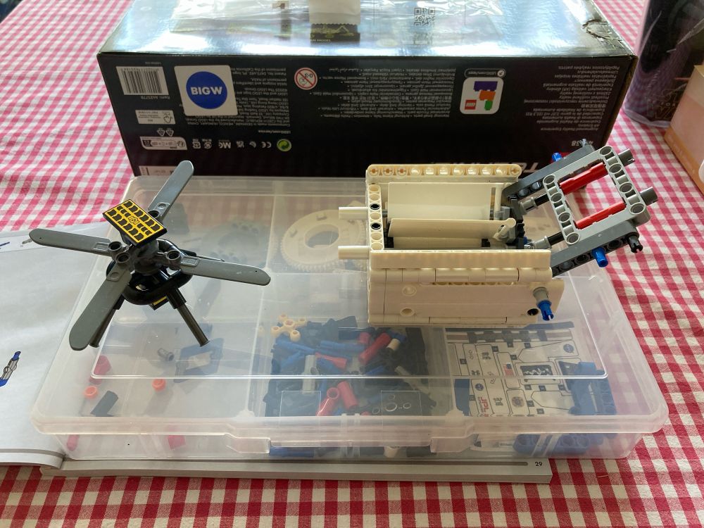 The Ingenuity helicopter next to the bare bones of the rover chassis