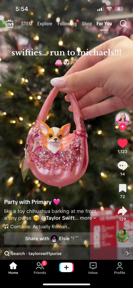 A Chihuahua in a tiny pink purse ornament 