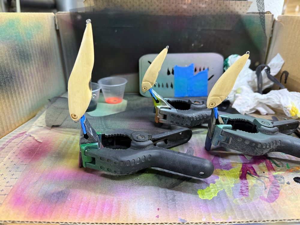 Three wooden lures ready to be painted