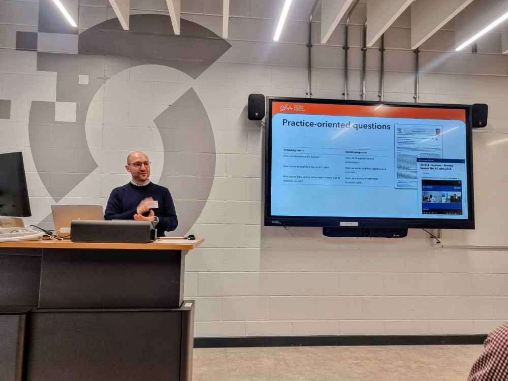 Professor Habli presenting in front of a screen with AI safety slides