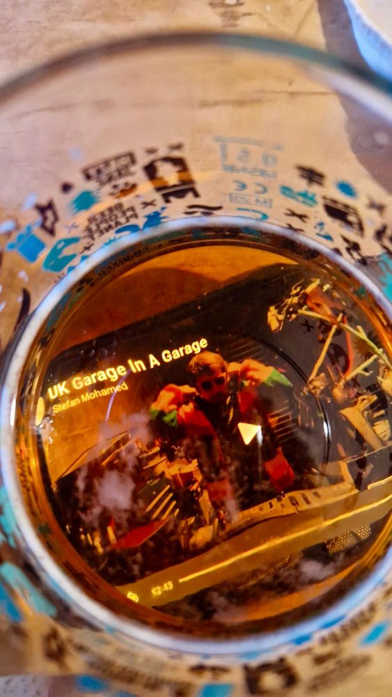 DJ Stef Mo UK garage in a garage mix on YouTube reflected in a pint of ale